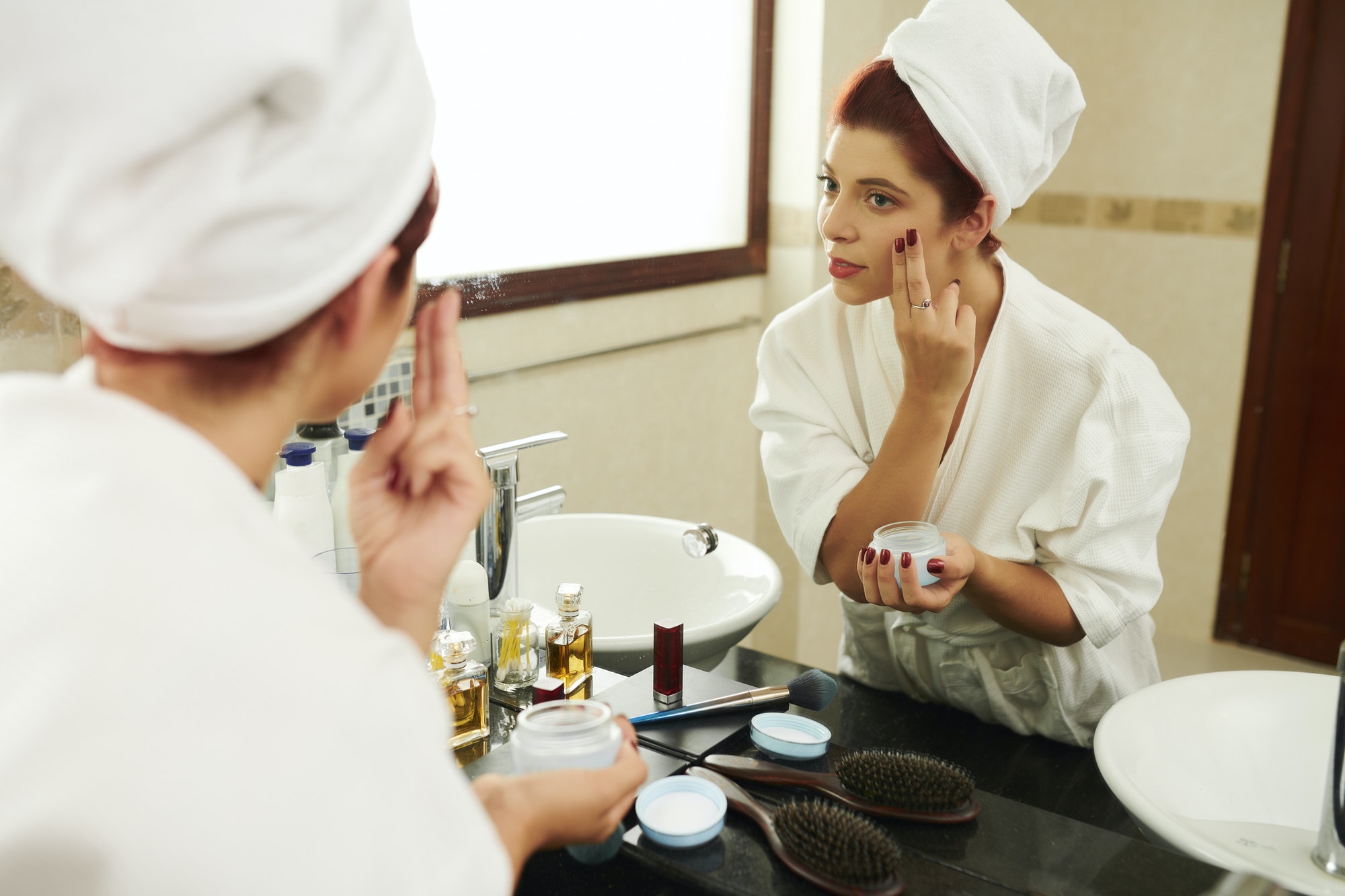 Woman applying moisturizing lotion